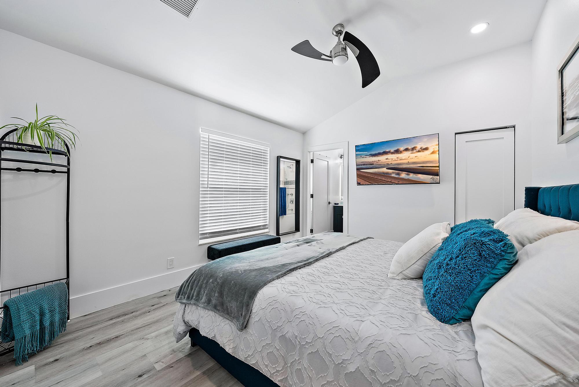 596 North Cypress Drive Tequesta, FL 33469 - Photo 23 of 28 a bedroom with a bed and dresser