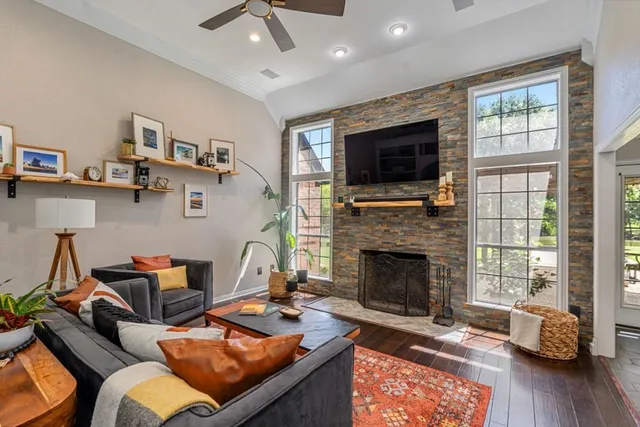 a living room with furniture fireplace and flat screen tv