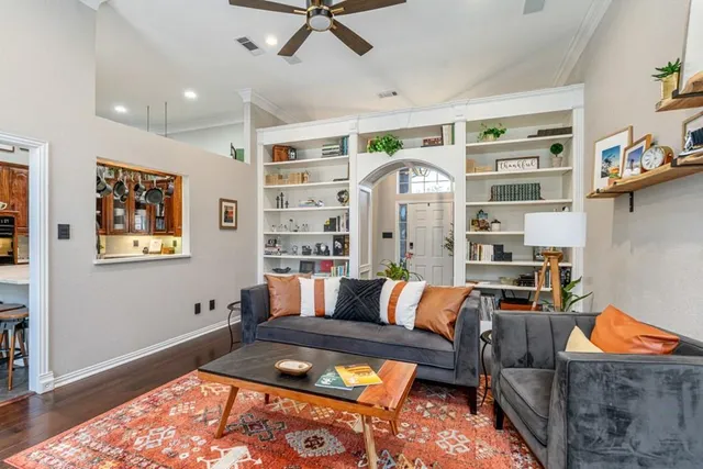 a living room with furniture a rug and a table