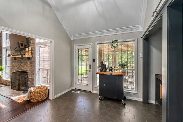 a view of a livingroom with a fireplace and wooden floor