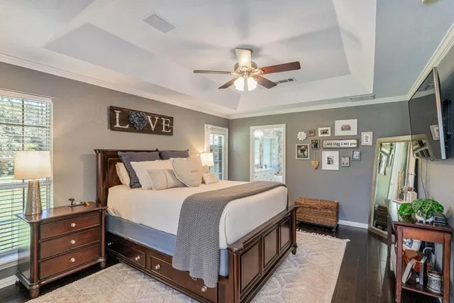 a bedroom with a bed dresser and a window