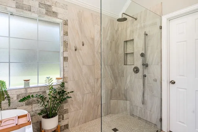 a bathroom with a shower and a sink