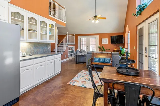 a kitchen with a table chairs stove and cabinets
