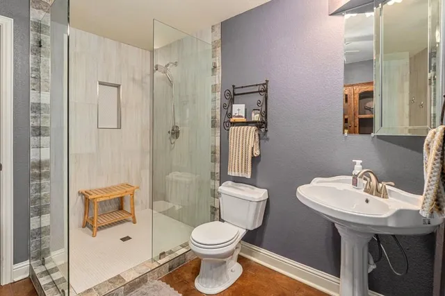 a bathroom with a sink toilet and shower
