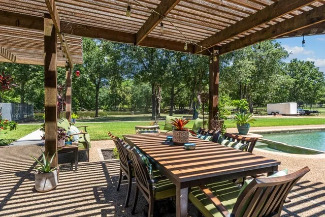 a view of a patio with a table chairs and a backyard