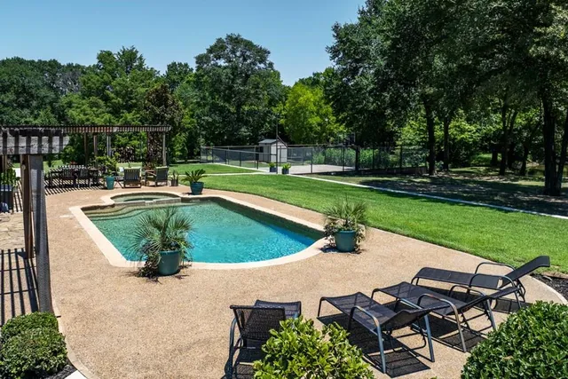 an aerial view of a house having swimming pool patio and garden