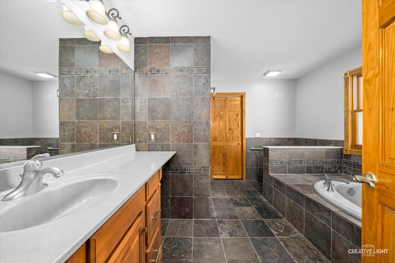 1111 Laurel Drive Aurora, IL 60506 - Photo 14 of 22 a bathroom with a granite countertop sink a toilet and shower