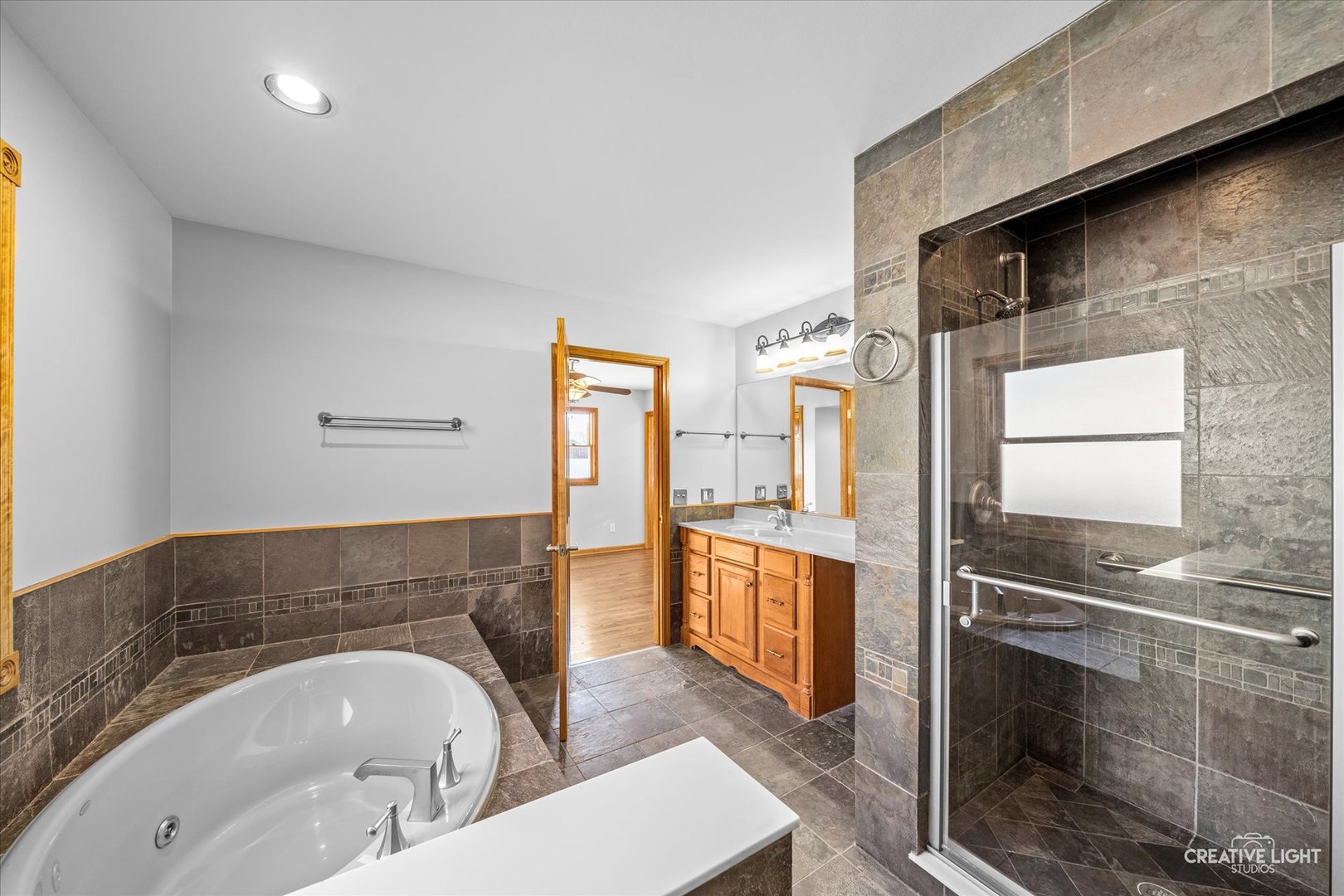 1111 Laurel Drive Aurora, IL 60506 - Photo 15 of 22 a spacious bathroom with a tub sink and mirror