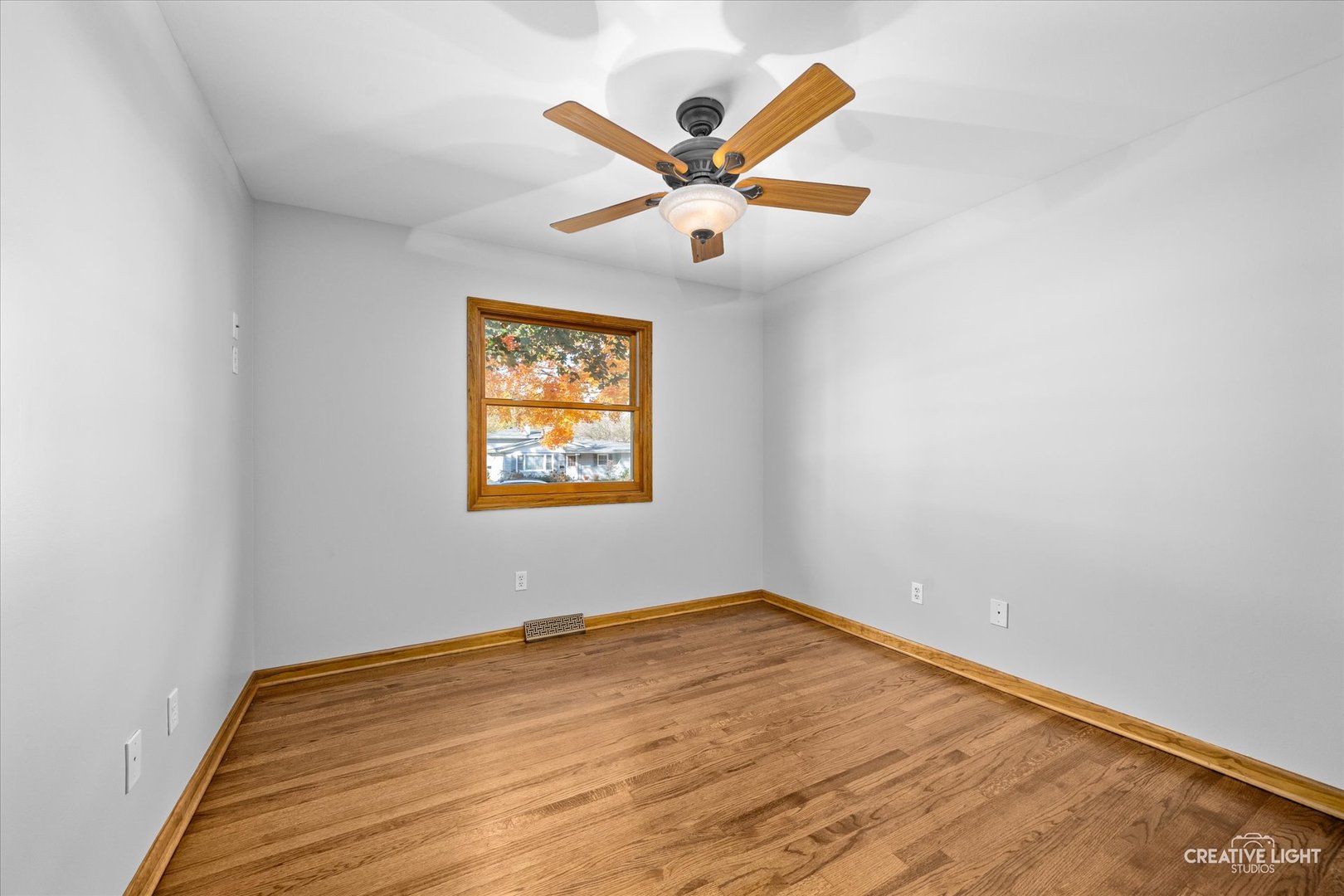 1111 Laurel Drive Aurora, IL 60506 - Photo 16 of 22 an empty room with wooden floor and ceiling fan