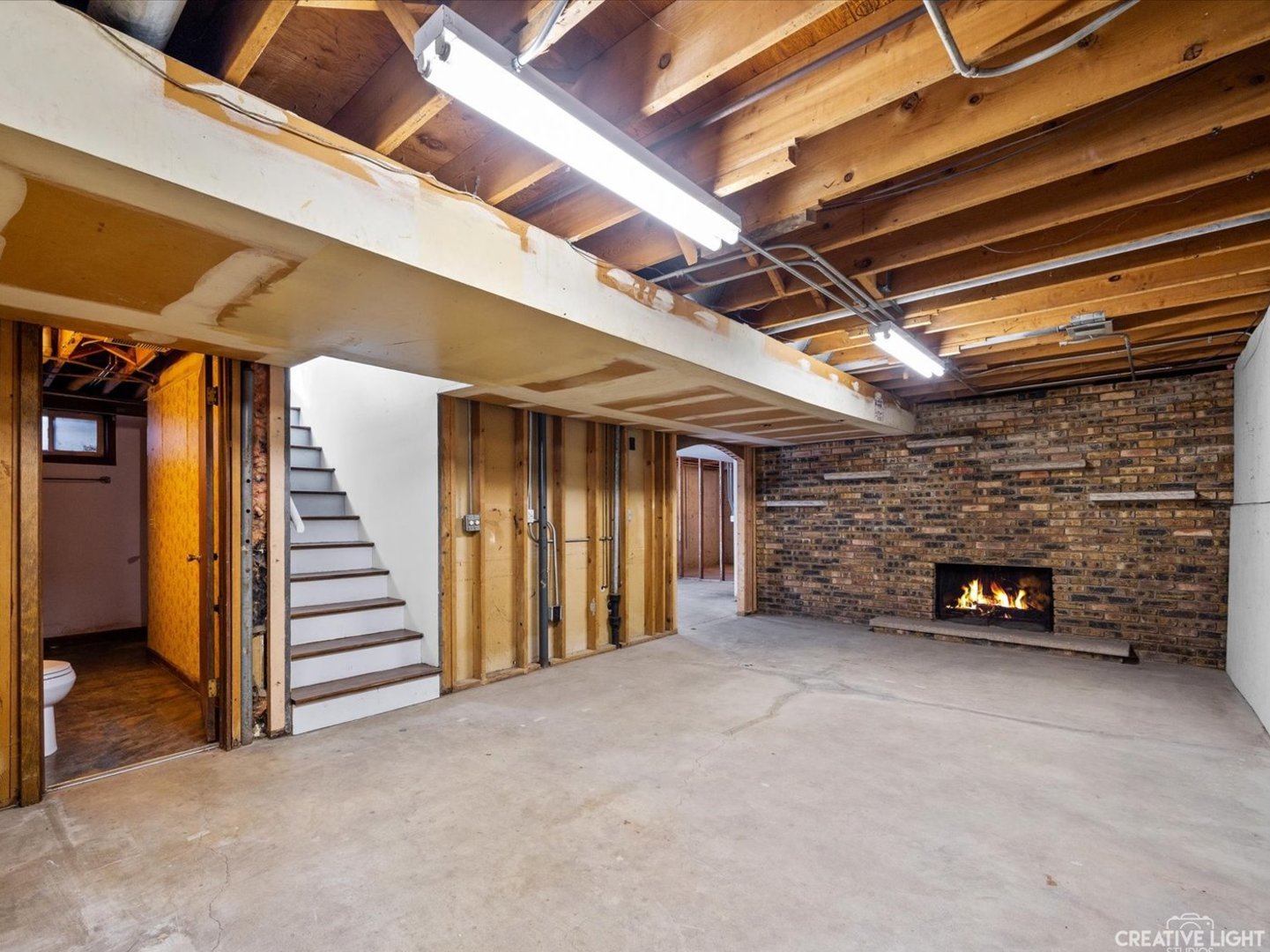 1111 Laurel Drive Aurora, IL 60506 - Photo 19 of 22 a view of an empty room with stairs and a couch