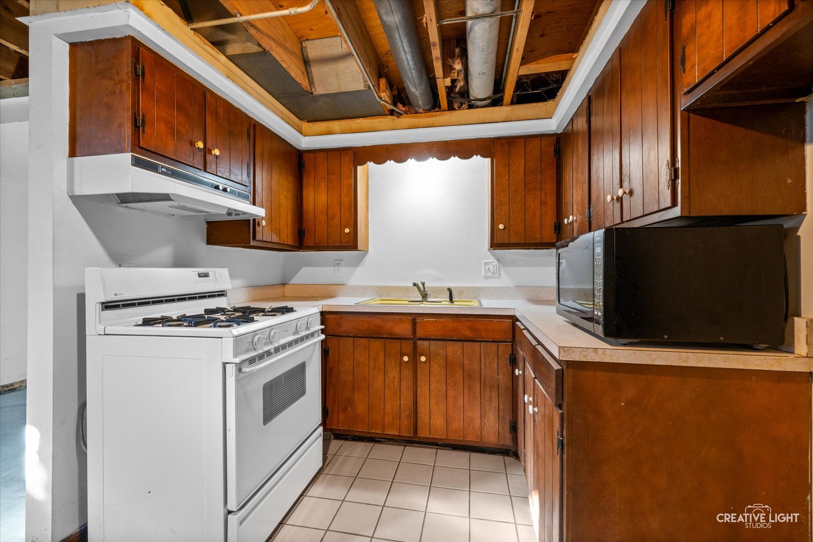 1111 Laurel Drive Aurora, IL 60506 - Photo 20 of 22 a kitchen with stainless steel appliances granite countertop a stove a sink and a microwave