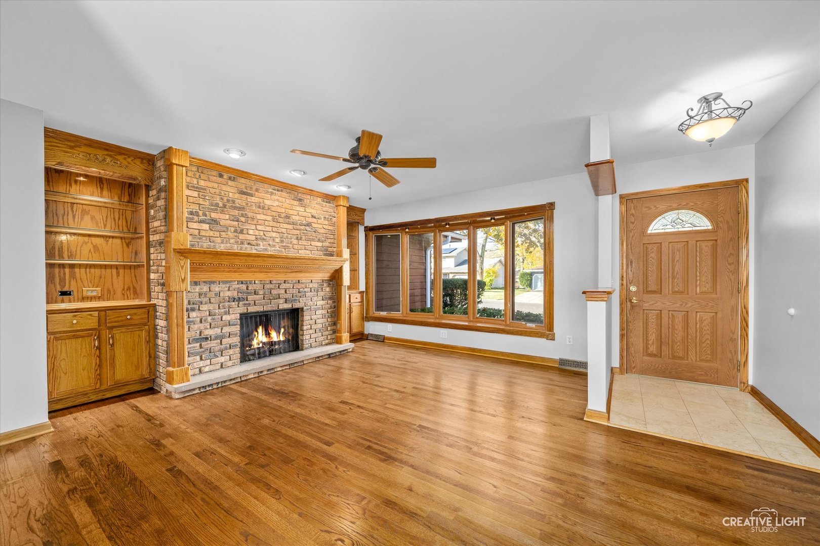 1111 Laurel Drive Aurora, IL 60506 - Photo 2 of 22 a view of an empty room with a fireplace and a window