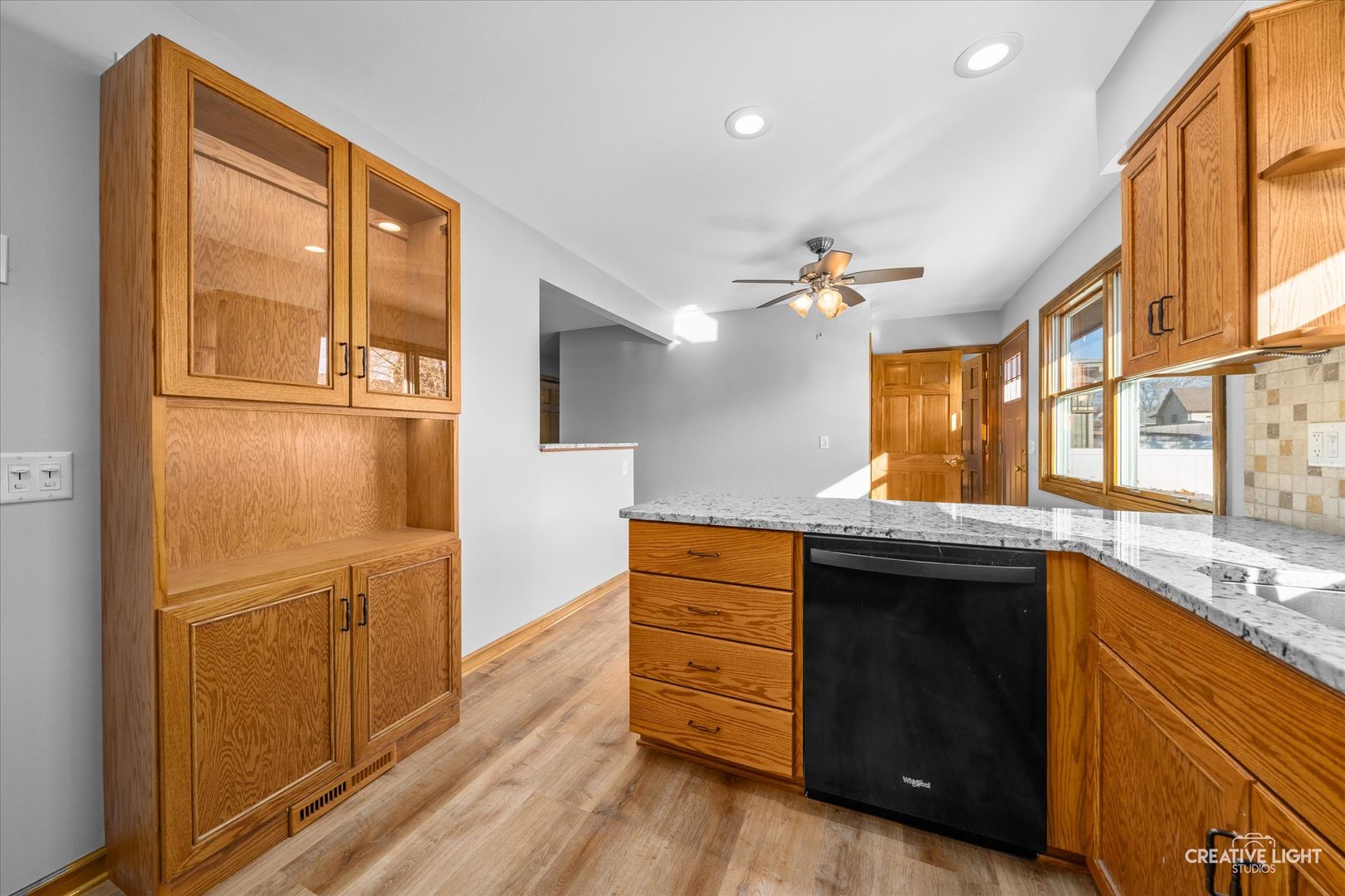 1111 Laurel Drive Aurora, IL 60506 - Photo 7 of 22 a kitchen with stainless steel appliances granite countertop a refrigerator a sink dishwasher and wooden cabinets with wooden floor