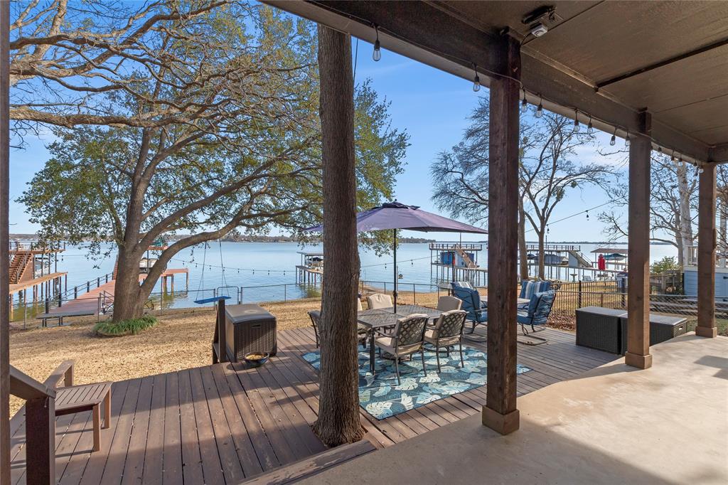 226 Palisade Loop Mabank, TX 75156 - Photo 1 of 1 a view of a porch with wooden floor and bench next to a yard