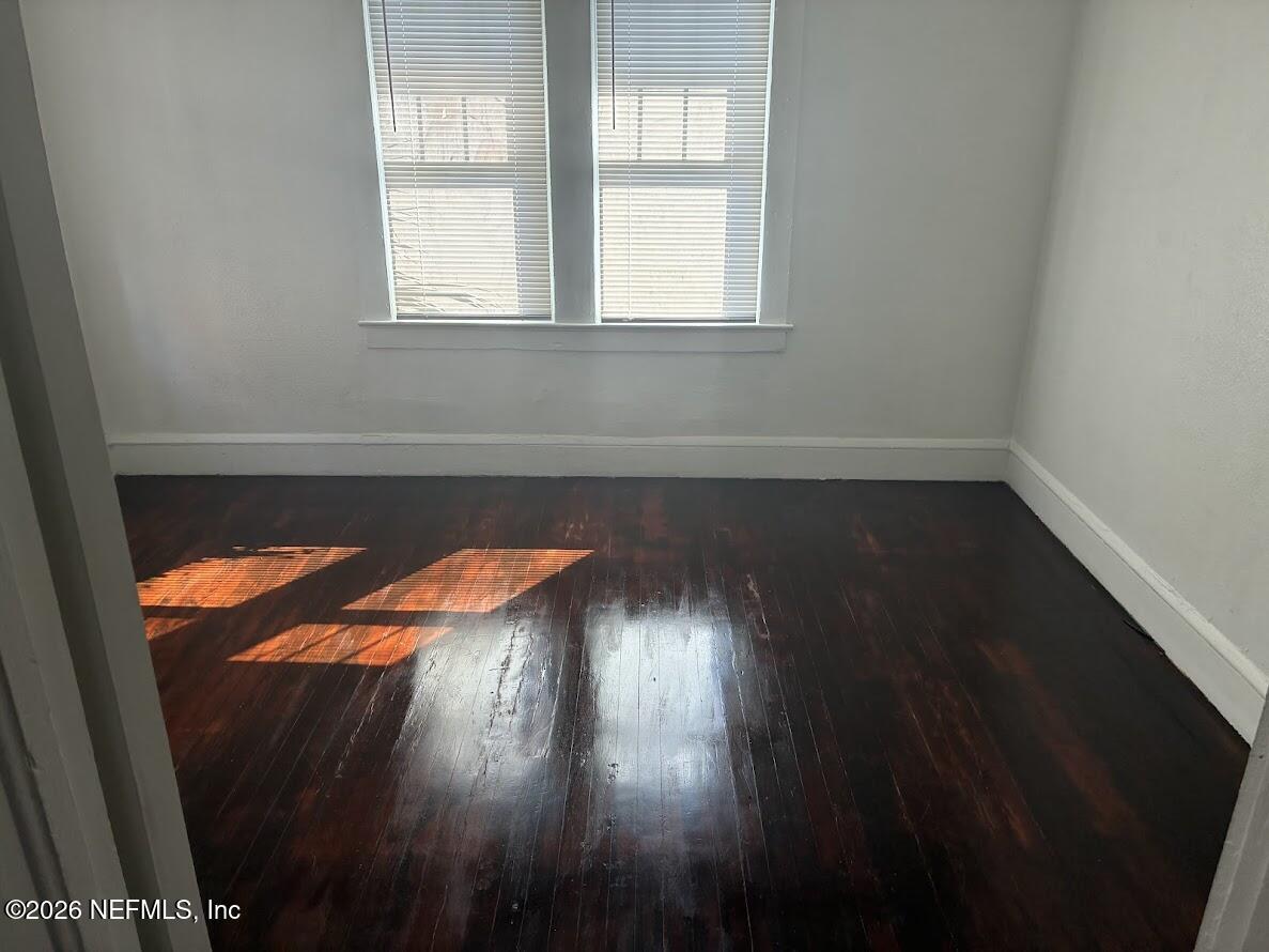 2036 Moncrief Road Jacksonville, FL 32209 - Photo 20 of 32 an empty room with wooden floor and windows