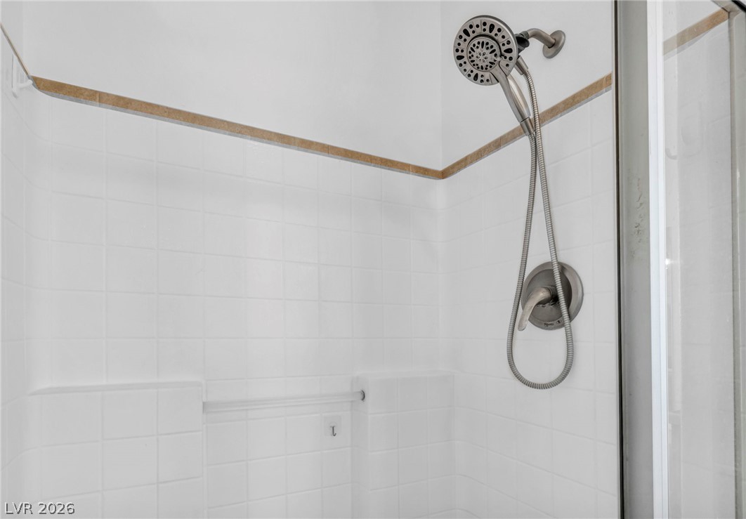 225 California Street Searchlight, NV 89046 - Photo 44 of 64 A well-maintained shower with crisp white tiling and a modern fixture offers a refreshing bathing experience.