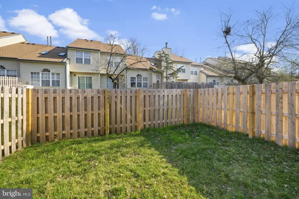 a view of a house with wooden fence