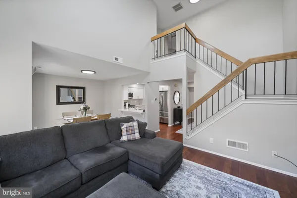 a living room with furniture and stairs