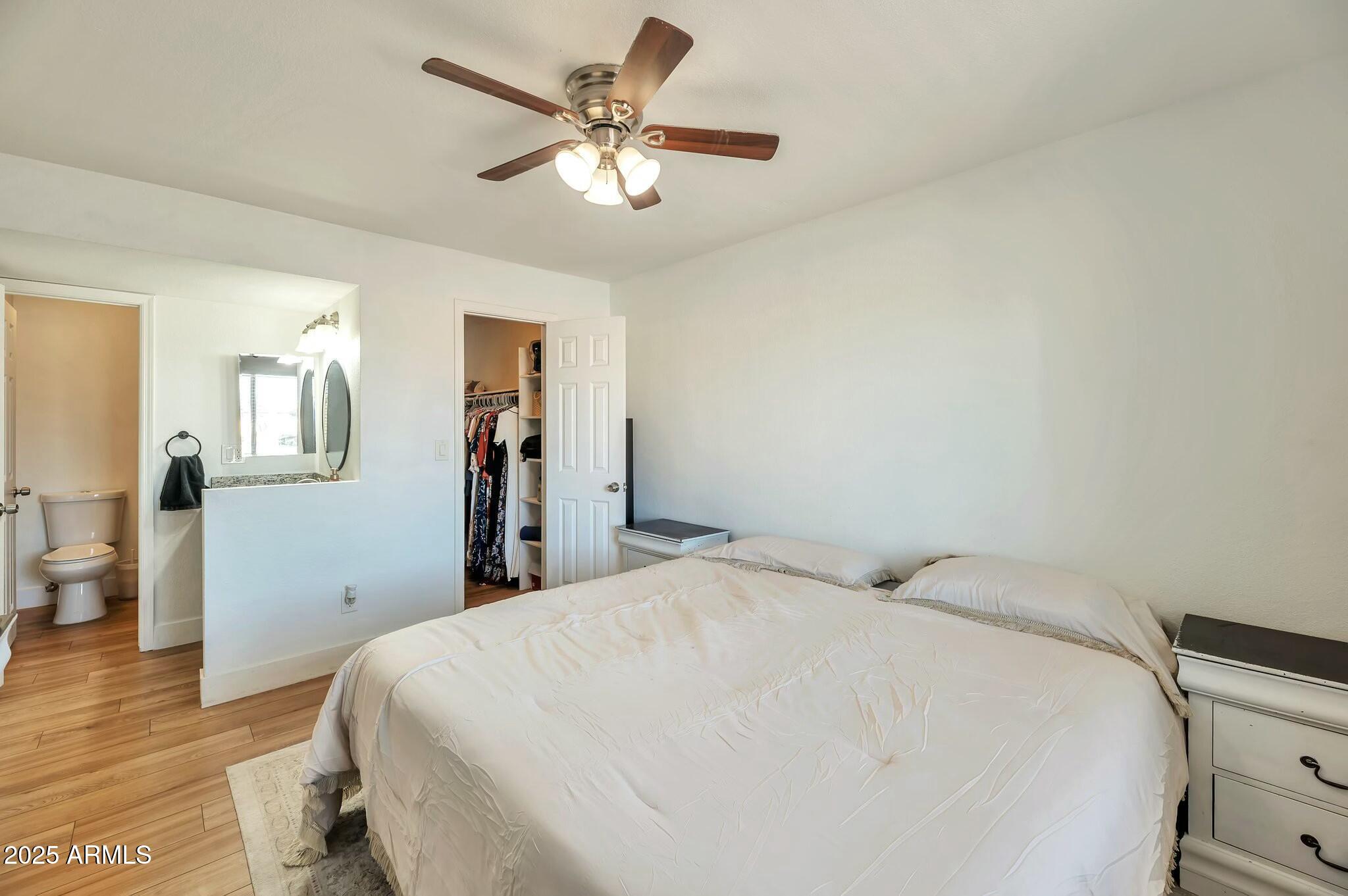623 West Guadalupe Road, Unit 213 Mesa, AZ 85210 - Photo 13 of 21 a bed room with a bed and a chandelier