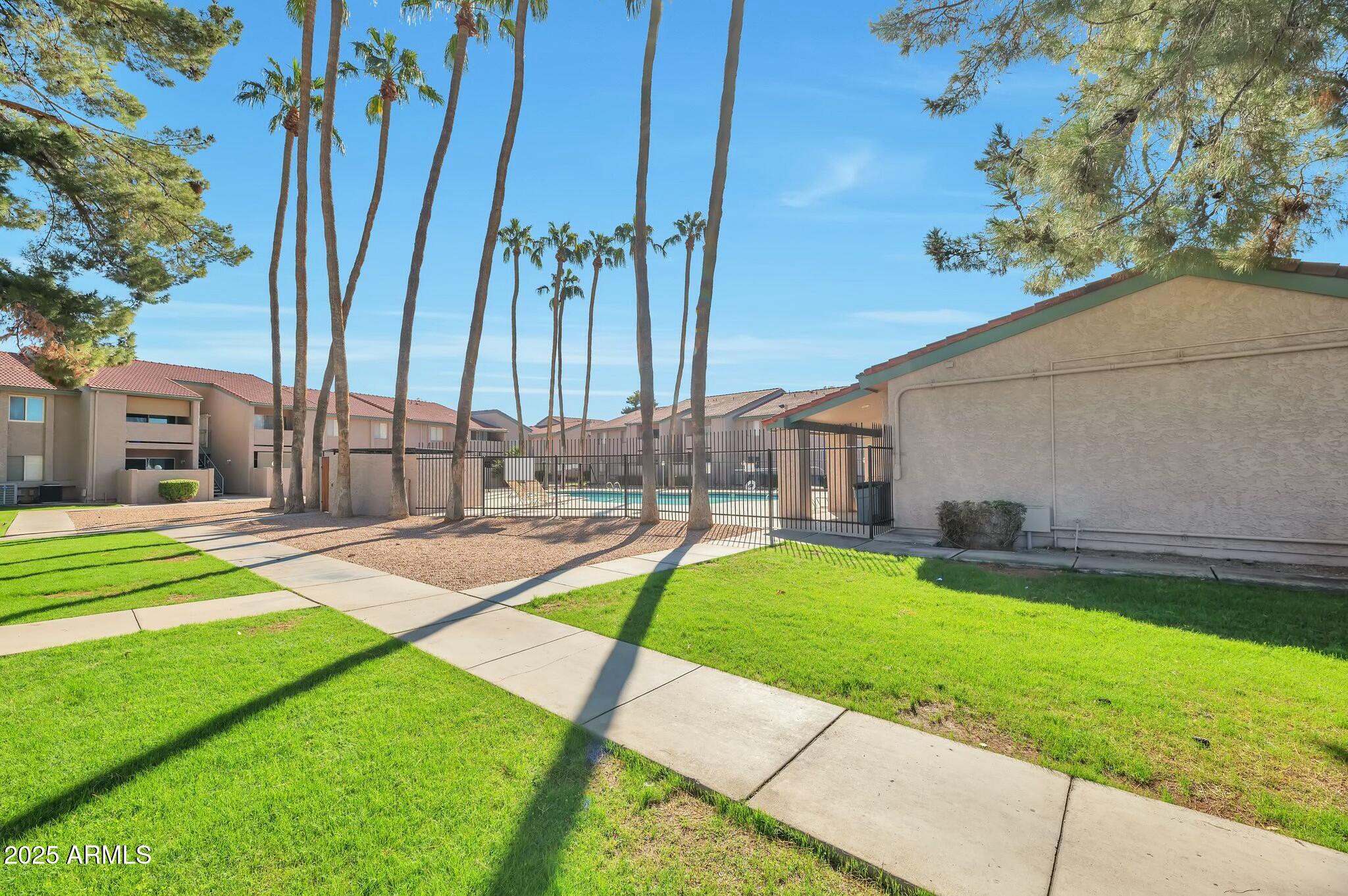 623 West Guadalupe Road, Unit 213 Mesa, AZ 85210 - Photo 17 of 21 a front view of a house with a yard