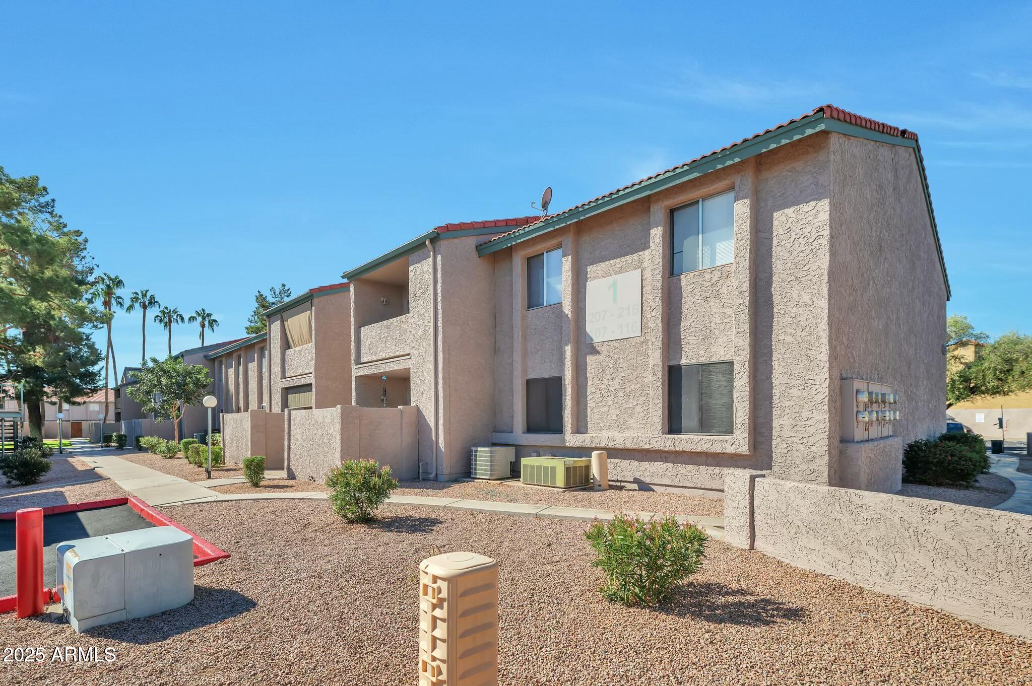 623 West Guadalupe Road, Unit 213 Mesa, AZ 85210 - Photo 18 of 21 a front view of a house with porch and outdoor seating