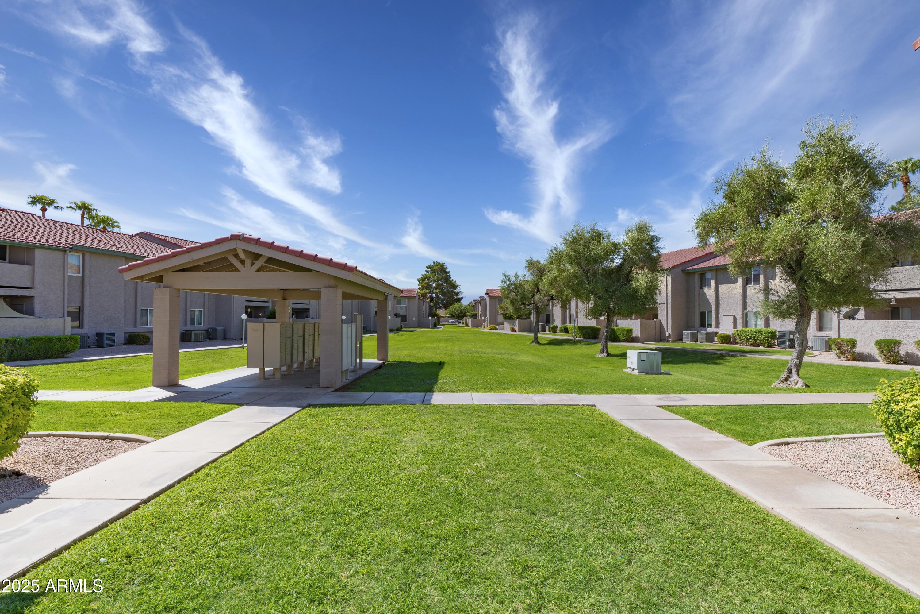 623 West Guadalupe Road, Unit 213 Mesa, AZ 85210 - Photo 20 of 21 a front view of a house with a yard and trees