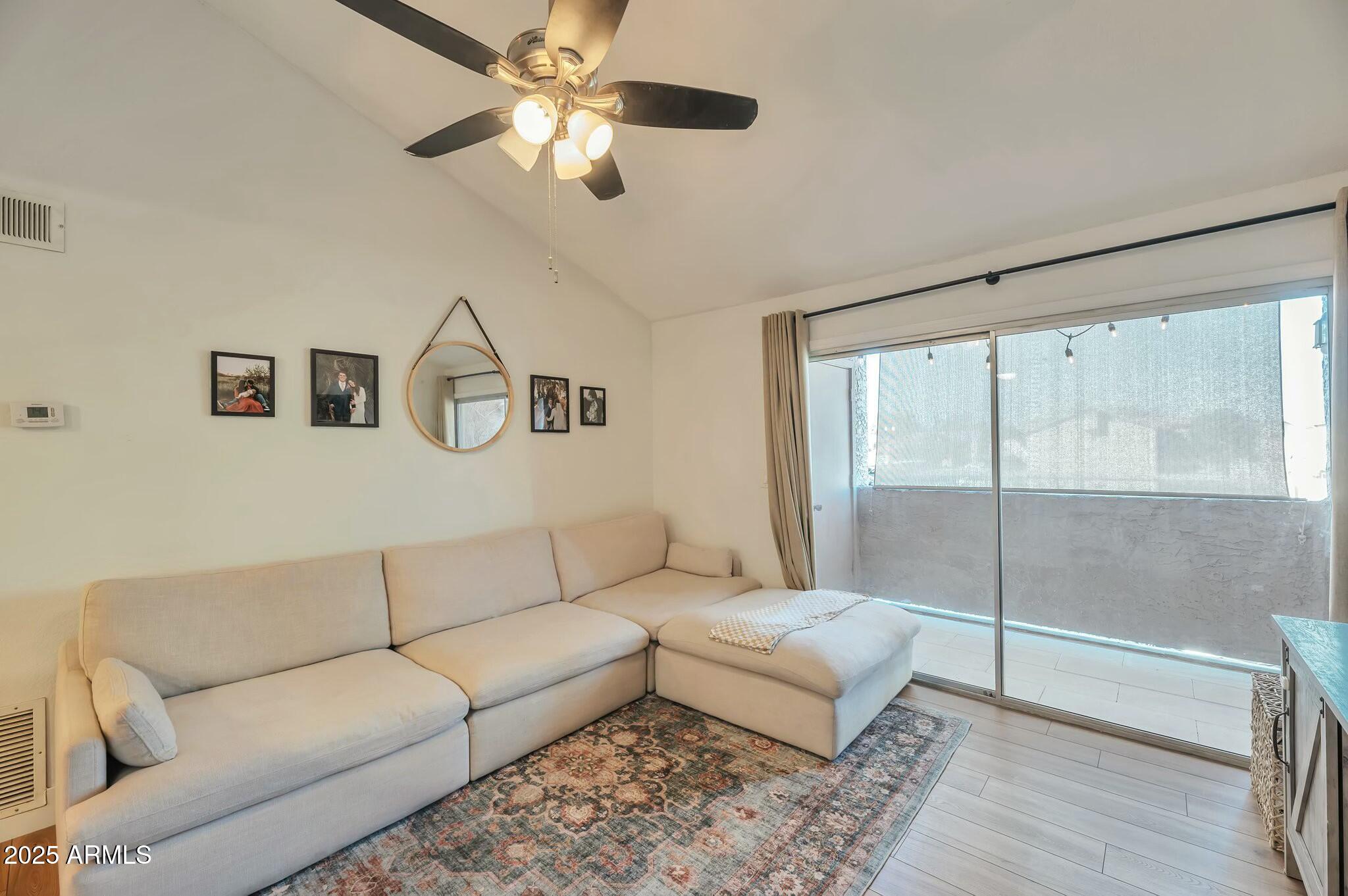623 West Guadalupe Road, Unit 213 Mesa, AZ 85210 - Photo 2 of 21 a living room with furniture and a ceiling fan