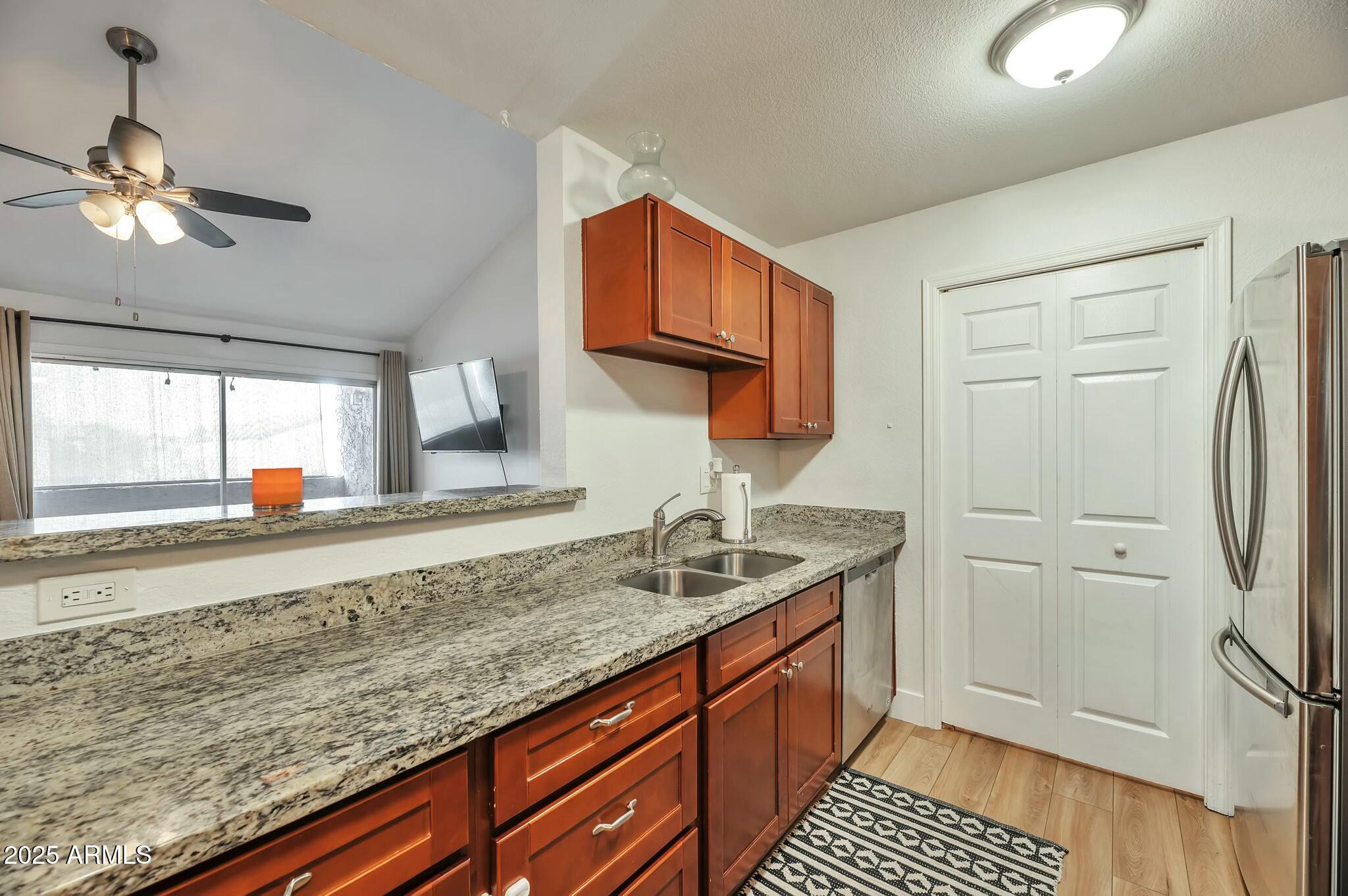 623 West Guadalupe Road, Unit 213 Mesa, AZ 85210 - Photo 4 of 21 a kitchen with stainless steel appliances granite countertop a sink stove and refrigerator