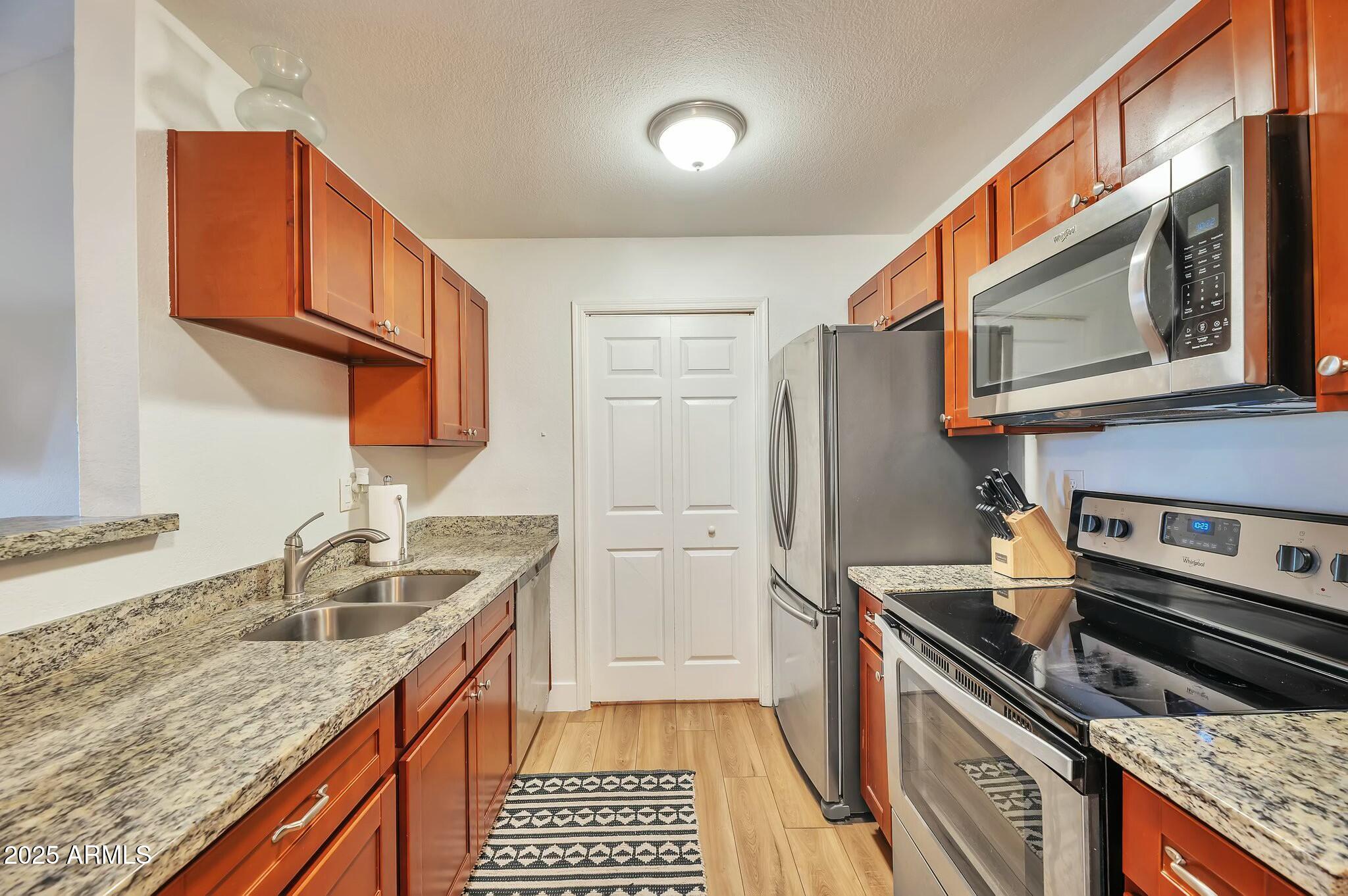 623 West Guadalupe Road, Unit 213 Mesa, AZ 85210 - Photo 5 of 21 a kitchen with a sink stove and refrigerator