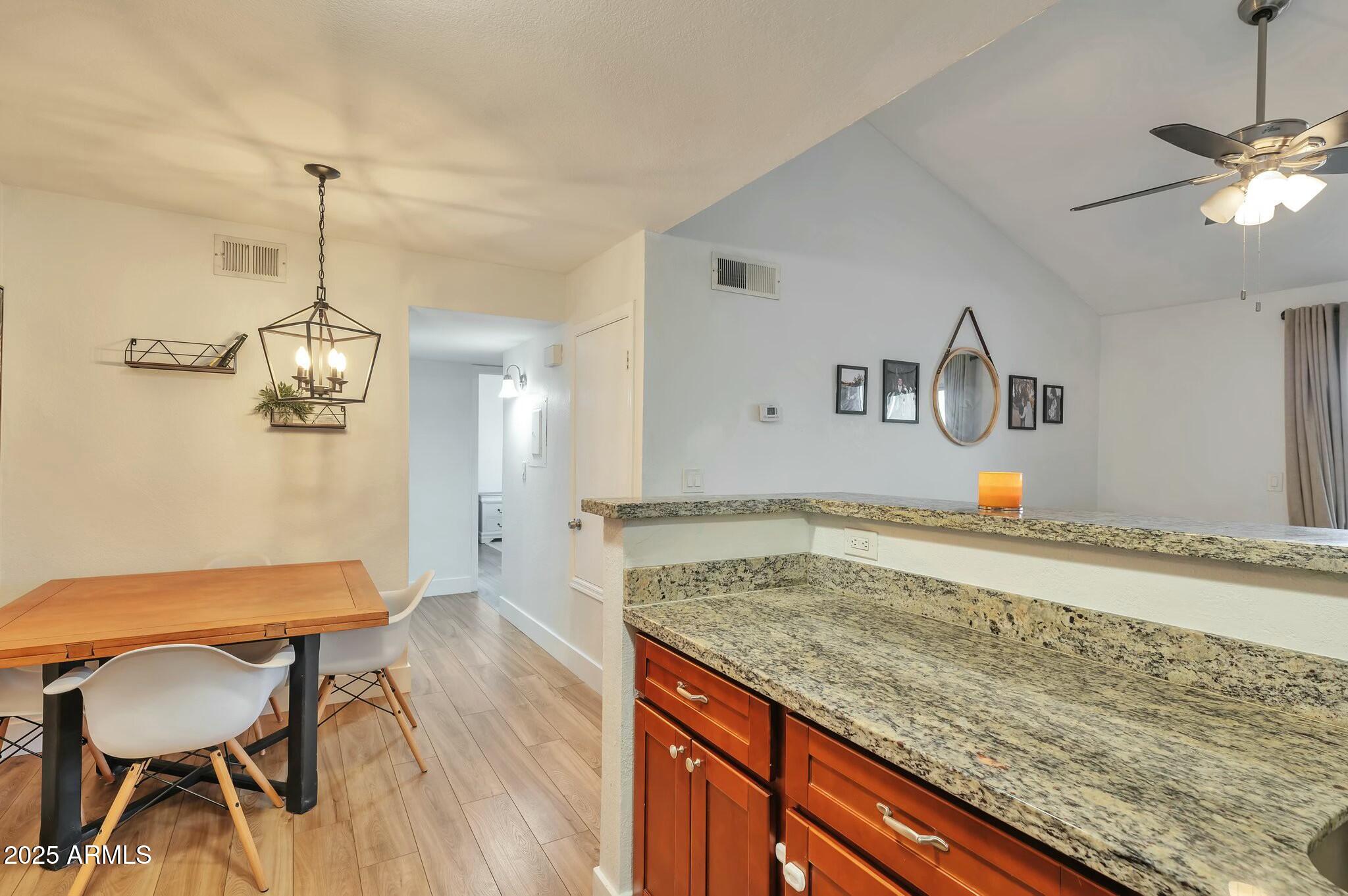 623 West Guadalupe Road, Unit 213 Mesa, AZ 85210 - Photo 6 of 21 a kitchen with a table and chairs in it
