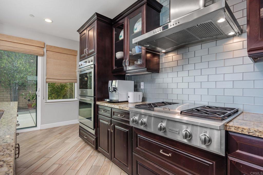 13525 Cielo Ranch Road San Diego, CA 92130 - Photo 15 of 49 a kitchen with a stove and wooden floor