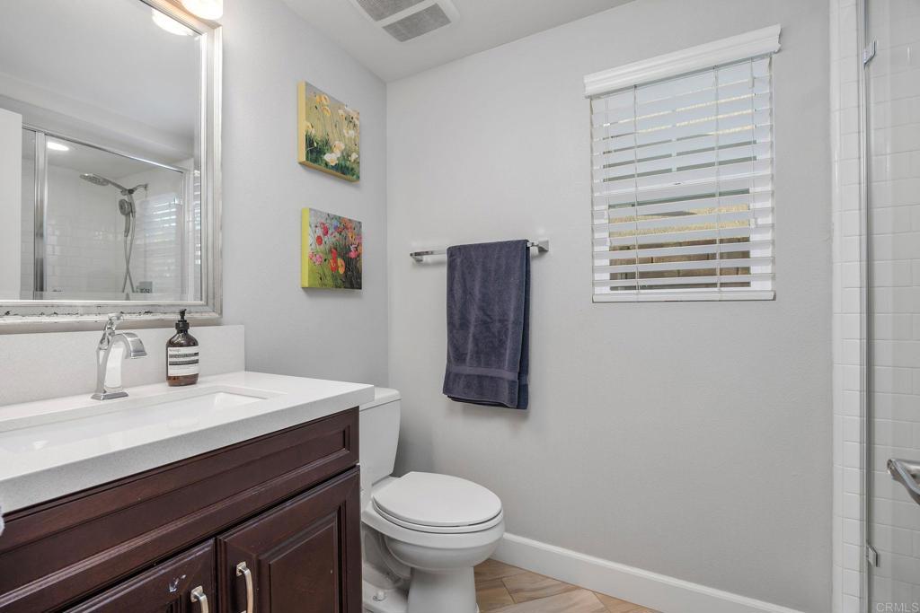 13525 Cielo Ranch Road San Diego, CA 92130 - Photo 17 of 49 a bathroom with a toilet a sink and mirror