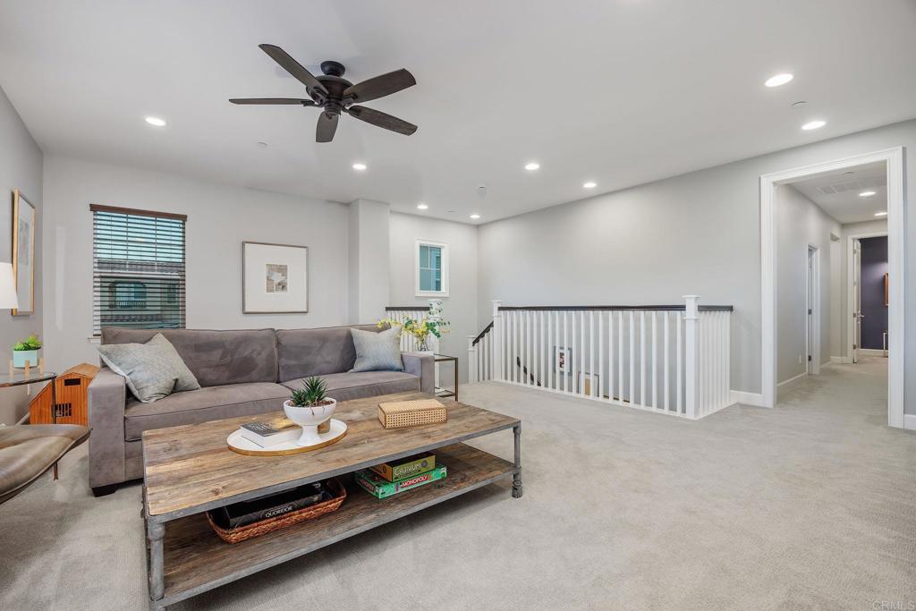 13525 Cielo Ranch Road San Diego, CA 92130 - Photo 19 of 49 a living room with furniture and a table with wooden floor