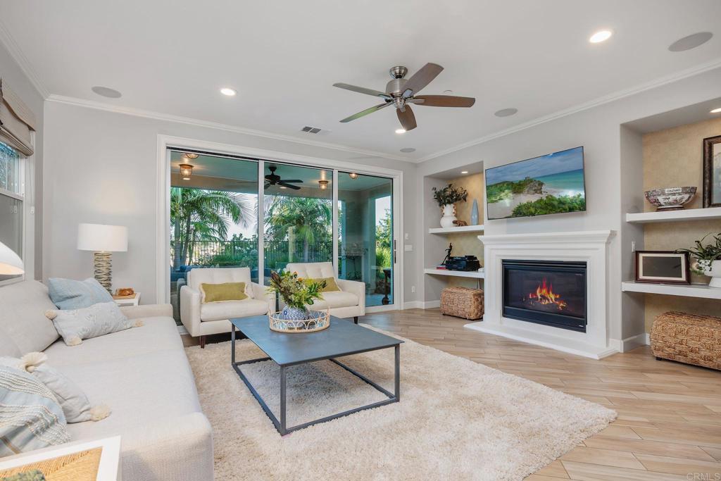 13525 Cielo Ranch Road San Diego, CA 92130 - Photo 10 of 49 a living room with furniture a fireplace and a large window