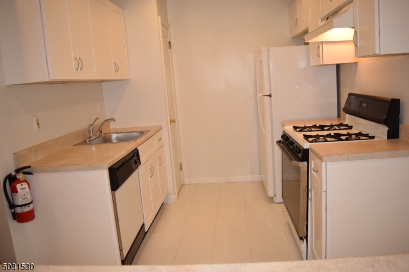 177 Riveredge Drive Chatham, NJ 07928 - Photo 9 of 17 a kitchen that has a sink and a stove