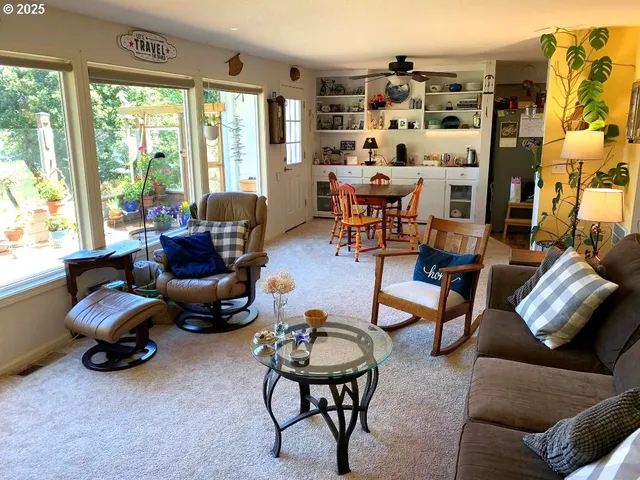 a living room with furniture and a floor to ceiling window