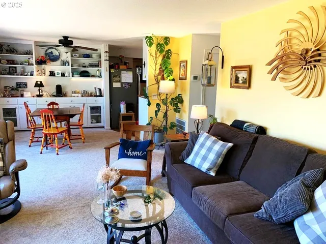 a living room with furniture and a lamp
