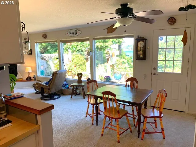 a dining room with furniture a chandelier and a rug