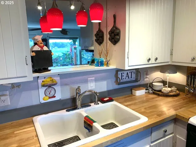 a kitchen with a stove a kitchen island with wooden cabinets