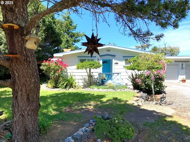 a view of a flower in a yard with a fountain