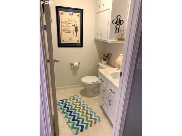 a bathroom with a toilet and a shower curtain