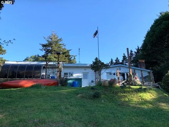 a view of a house with a big yard and potted plants