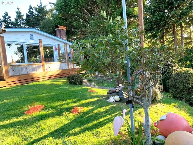 a front view of house with swimming pool and garden