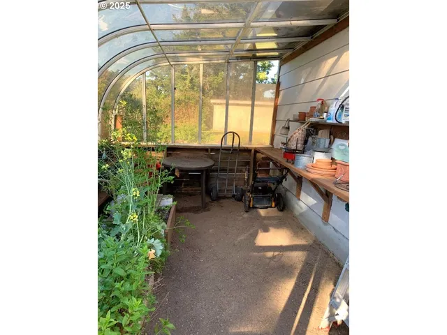 a room with lots of green space and a bench