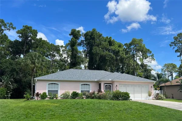 a front view of a house with a garden