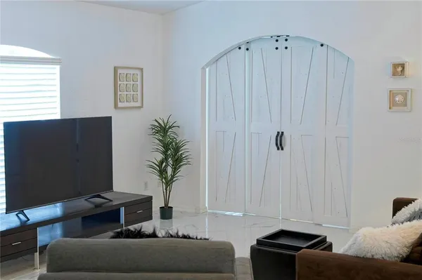 a living room with furniture and a flat screen tv