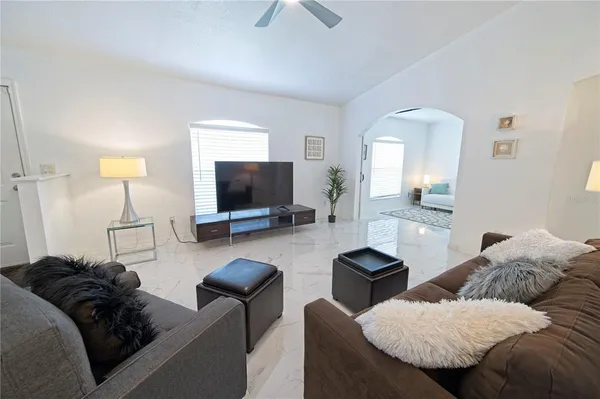a living room with furniture and a flat screen tv