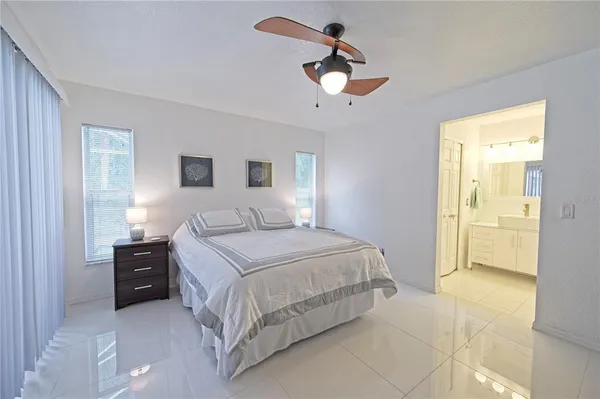 a bedroom with a bed and painting on the wall