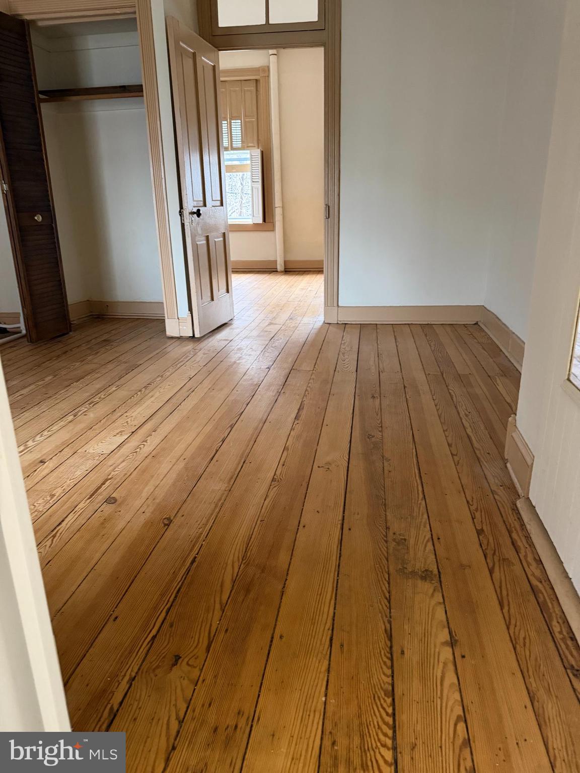 232 East 2nd Street Frederick, MD 21701 - Photo 14 of 40 a view of an empty room with wooden floor and a window