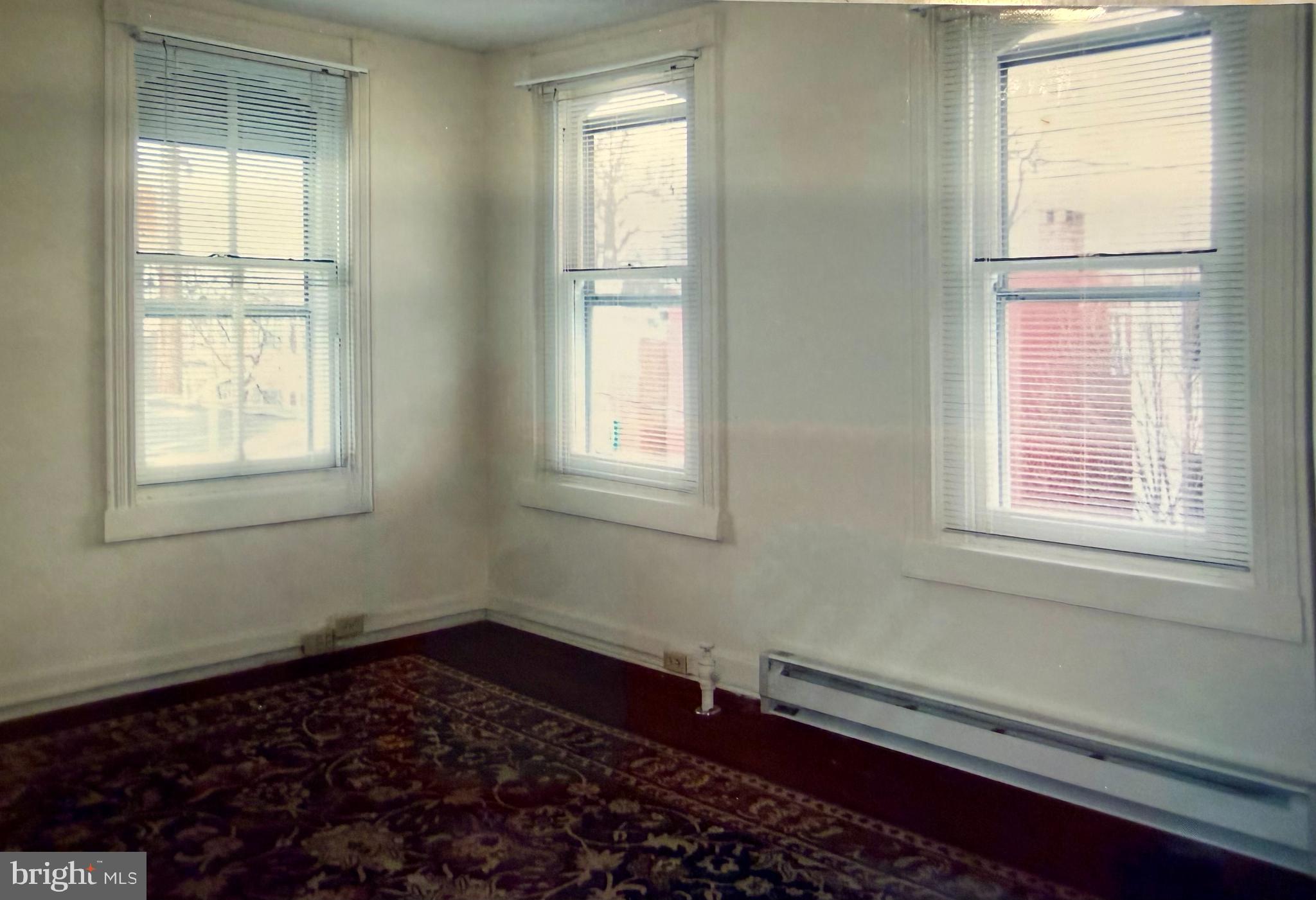 232 East 2nd Street Frederick, MD 21701 - Photo 16 of 40 an empty room with wooden floor and windows